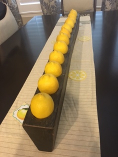 Use your ordinary home decor items to your advantage when hosting. The candles were removed from this wooden holder, and lemons added to the theme.